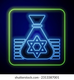 Glowing neon Jewish money bag with star of david icon isolated on blue background. Currency symbol.  Vector