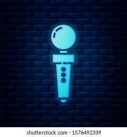Glowing neon Joystick for arcade machine icon isolated on brick wall background. Joystick gamepad.  Vector Illustration