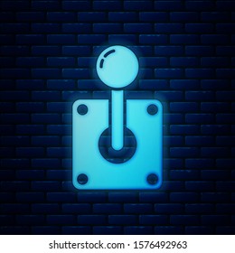 Glowing neon Joystick for arcade machine icon isolated on brick wall background. Joystick gamepad.  Vector Illustration