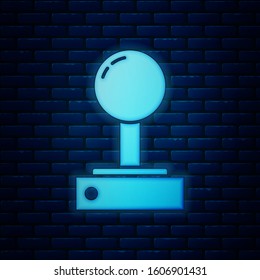 Glowing neon Joystick for arcade machine icon isolated on brick wall background. Joystick gamepad.  Vector Illustration