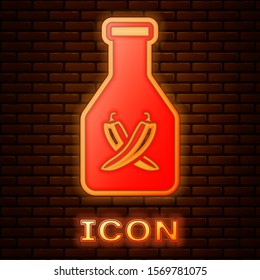 Glowing neon Ketchup bottle icon isolated on brick wall background. Hot chili pepper pod sign. Barbecue and BBQ grill symbol.  Vector Illustration