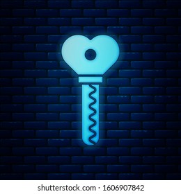 Glowing neon Key in heart shape icon isolated on brick wall background. Valentines day.  Vector Illustration