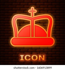 Glowing neon King crown icon isolated on brick wall background.  Vector Illustration