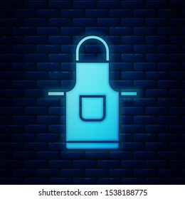 Glowing neon Kitchen apron icon isolated on brick wall background. Chef uniform for cooking.  Vector Illustration