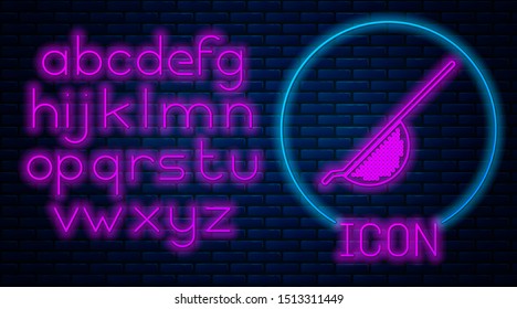 Glowing neon Kitchen colander icon isolated on brick wall background. Cooking utensil. Cutlery sign. Neon light alphabet. Vector Illustration