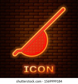 Glowing neon Kitchen colander icon isolated on brick wall background. Cooking utensil. Cutlery sign.  Vector Illustration