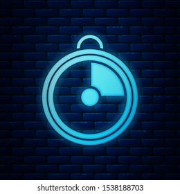 Glowing neon Kitchen timer icon isolated on brick wall background. Cooking utensil.  Vector Illustration