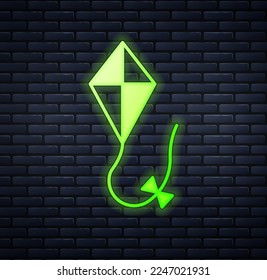 Glowing neon Kite icon isolated on brick wall background.  Vector