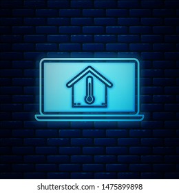 Glowing neon Laptop with house temperature icon isolated on brick wall background. Thermometer icon.  Vector Illustration