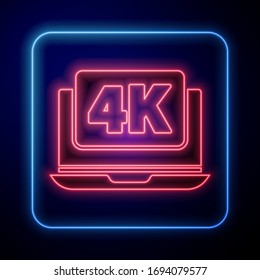 Glowing neon Laptop screen with 4k video technology icon isolated on blue background.  Vector Illustration