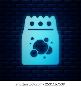 Glowing neon Laundry detergent for automatic wash machine icon isolated on brick wall background.  Vector