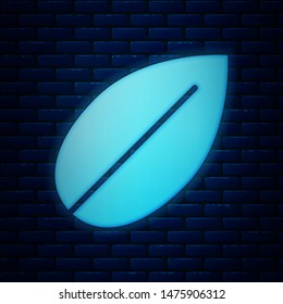 Glowing neon Leaf icon isolated on brick wall background. Fresh natural product symbol.  Vector Illustration