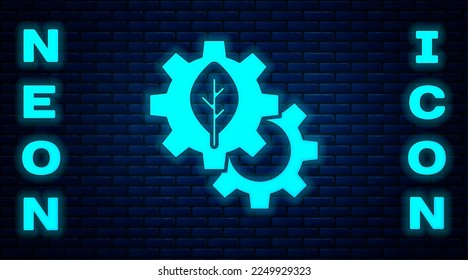Glowing neon Leaf plant ecology in gear machine icon isolated on brick wall background. Eco friendly technology. World Environment day label.  Vector