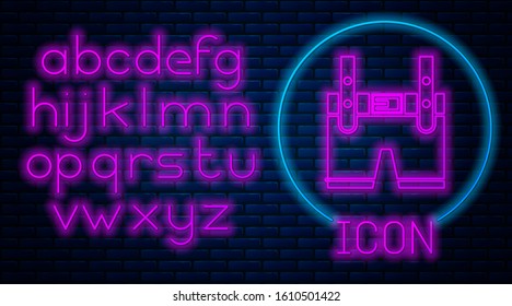 Glowing neon Lederhosen icon isolated on brick wall background. Traditional bavarian clothing. Oktoberfest outfit. Pants with suspenders. Patrick day. Neon light alphabet. Vector Illustration