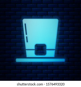 Glowing neon Leprechaun hat icon isolated on brick wall background. Happy Saint Patricks day.  Vector Illustration