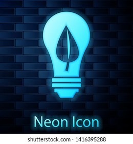 Glowing neon Light bulb with leaf icon isolated on brick wall background. Eco energy concept. Alternative energy concept. Vector Illustration