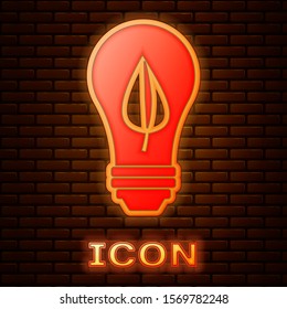 Glowing neon Light bulb with leaf icon isolated on brick wall background. Eco energy concept. Alternative energy concept.  Vector Illustration