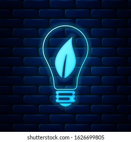 Glowing neon Light bulb with leaf icon isolated on brick wall background. Eco energy concept.  Vector Illustration