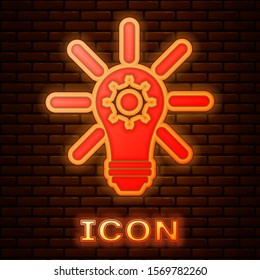 Glowing neon Light bulb with rays shine and gear inside icon isolated on brick wall background. Innovation concept.  Vector Illustration