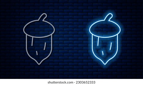 Glowing neon line Acorn, oak nut, seed icon isolated on brick wall background. Vector