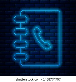 Glowing neon line Address book icon isolated on brick wall background. Notebook, address, contact, directory, phone, telephone book icon.  Vector Illustration