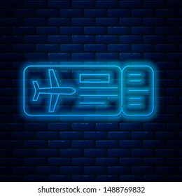 Glowing neon line Airline ticket icon isolated on brick wall background. Plane ticket.  Vector Illustration