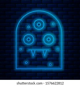 Glowing neon line Alien icon isolated on brick wall background. Extraterrestrial alien face or head symbol.  Vector Illustration