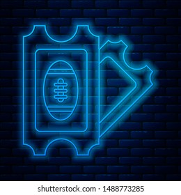 Glowing neon line American Football ticket icon isolated on brick wall background.  Vector Illustration