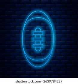 Glowing neon line American Football ball icon isolated on brick wall background. Rugby ball icon. Team sport game symbol.  Vector