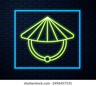 Glowing neon line Asian or Chinese conical straw hat icon isolated on brick wall background.  Vector