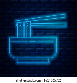 Glowing neon line Asian noodles in bowl and chopsticks icon isolated on brick wall background. Street fast food. Korean, Japanese, Chinese food.  Vector Illustration
