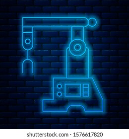Glowing neon line Assembly line icon isolated on brick wall background. Automatic production conveyor. Robotic industry concept.  Vector Illustration