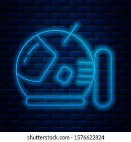 Glowing neon line Astronaut helmet icon isolated on brick wall background.  Vector Illustration