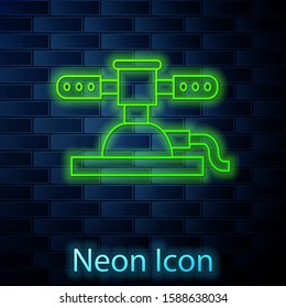 Glowing neon line Automatic irrigation sprinklers icon isolated on brick wall background. Watering equipment. Garden element. Spray gun icon.  Vector Illustration