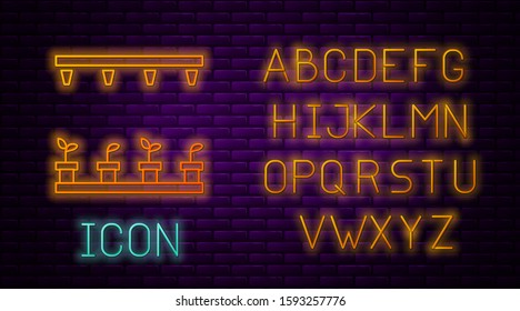 Glowing neon line Automatic irrigation sprinklers icon isolated on brick wall background. Watering equipment. Garden element. Spray gun icon. Neon light alphabet. Vector Illustration