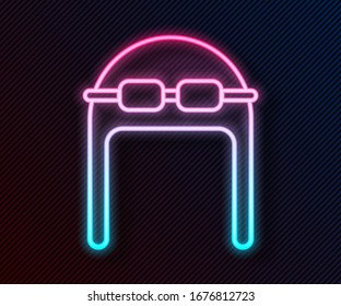 Glowing neon line Aviator hat with goggles icon isolated on black background. Pilot hat.  Vector Illustration