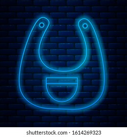 Glowing neon line Baby bib icon isolated on brick wall background.  Vector Illustration