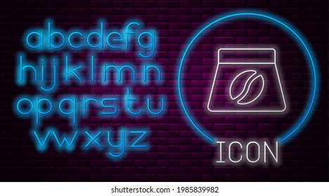 Glowing neon line Bag of coffee beans icon isolated on brick wall background. Neon light alphabet. Vector