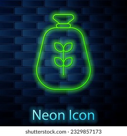 Glowing neon line Bag of flour icon isolated on brick wall background.  Vector