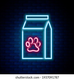 Glowing neon line Bag of food for pet icon isolated on brick wall background. Food for animals. Pet food package. Dog or cat paw print. Colorful outline concept. Vector