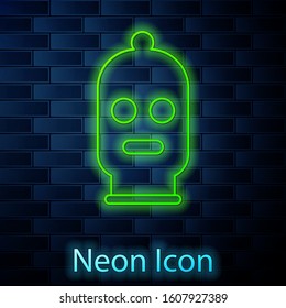 Glowing neon line Balaclava icon isolated on brick wall background. A piece of clothing for winter sports or a mask for a criminal or a thief.  Vector Illustration