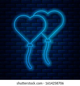 Glowing neon line Balloons in form of heart with ribbon icon isolated on brick wall background. Valentines day.  Vector Illustration