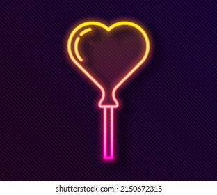 Glowing neon line Balloons in form of heart with ribbon icon isolated on black background.  Vector