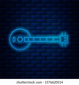 Glowing neon line Banjo icon isolated on brick wall background. Musical instrument.  Vector Illustration