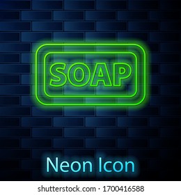 Glowing neon line Bar of soap icon isolated on brick wall background. Soap bar with bubbles. Vector Illustration