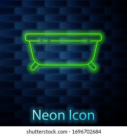 Glowing neon line Bathtub icon isolated on brick wall background. Vector Illustration