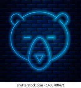 Glowing neon line Bear head icon isolated on brick wall background.  Vector Illustration