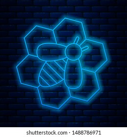 Glowing neon line Bee and honeycomb icon isolated on brick wall background. Honey cells. Honeybee or apis with wings symbol. Flying insect. Sweet natural food.  Vector Illustration