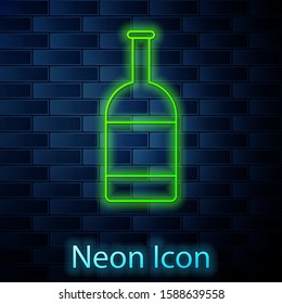 Glowing neon line Beer bottle icon isolated on brick wall background.  Vector Illustration