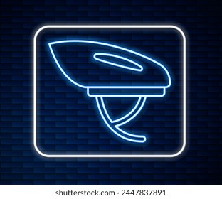 Glowing neon line Bicycle helmet icon isolated on brick wall background. Extreme sport. Sport equipment.  Vector